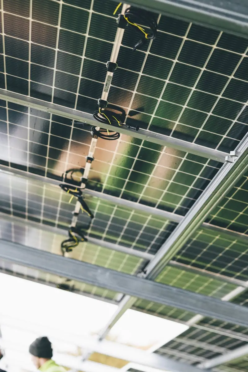 Close-up of solar panels being installed outdoors with technicians visible.