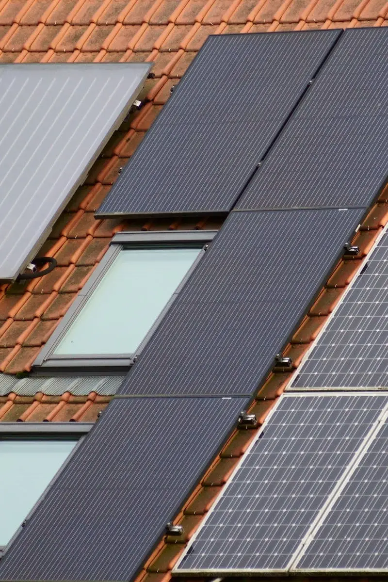 Close-up of solar panels on a tiled roof, showcasing sustainable energy solutions.